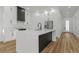Modern kitchen with white cabinets, island, and stainless steel appliances at 1696 Wilmar Ave, Tarpon Springs, FL 34689