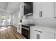 Modern kitchen with white cabinets, stainless steel appliances and hardwood floors at 1696 Wilmar Ave, Tarpon Springs, FL 34689