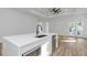 Modern kitchen island with white quartz countertops and stainless steel appliances at 1696 Wilmar Ave, Tarpon Springs, FL 34689