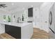 Modern kitchen with white cabinets, large island, and stainless steel appliances at 1696 Wilmar Ave, Tarpon Springs, FL 34689