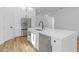 Modern kitchen island with white quartz countertops and stainless steel appliances at 1696 Wilmar Ave, Tarpon Springs, FL 34689