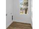 Laundry room with wood-look floors and a window providing natural light at 1696 Wilmar Ave, Tarpon Springs, FL 34689