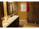 Bathroom with double vanity, granite countertop and shower at 17346 Mint Leaf Ln, Land O Lakes, FL 34638