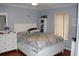 Bright bedroom featuring a queen-size bed and white dresser at 17346 Mint Leaf Ln, Land O Lakes, FL 34638