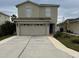 Two-story house with attached garage and well-maintained landscaping at 17346 Mint Leaf Ln, Land O Lakes, FL 34638