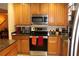 Modern kitchen with stainless steel appliances and wood cabinets at 17346 Mint Leaf Ln, Land O Lakes, FL 34638