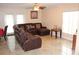 Spacious living room featuring a large sectional sofa and tile flooring at 17346 Mint Leaf Ln, Land O Lakes, FL 34638