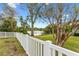 Landscaped backyard with white fence and lake view at 1758 Winfield Cir, Clearwater, FL 33756