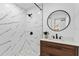 Modern bathroom with marble shower and wood vanity at 1758 Winfield Cir, Clearwater, FL 33756