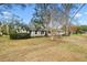 Home with mature trees and walkway leading to front door at 1758 Winfield Cir, Clearwater, FL 33756