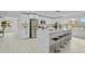 Open concept kitchen boasts white cabinets and a large island at 1758 Winfield Cir, Clearwater, FL 33756