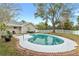 Inviting kidney-shaped pool with brick decking and fenced backyard at 1758 Winfield Cir, Clearwater, FL 33756