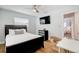 Guest bedroom with queen bed, TV and view into another bedroom at 1766 Montana Ne Ave, St Petersburg, FL 33703