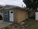 House exterior featuring stone and yellow siding, a landscaped yard, and a partially visible driveway at 1766 Montana Ne Ave, St Petersburg, FL 33703
