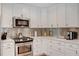 Modern kitchen with white cabinets, stainless steel appliances and quartz countertops at 1766 Montana Ne Ave, St Petersburg, FL 33703