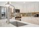 Modern kitchen with stainless steel appliances, white cabinets and quartz countertops at 1766 Montana Ne Ave, St Petersburg, FL 33703