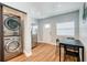Stackable washer and dryer in laundry room with additional small table and chair at 1766 Montana Ne Ave, St Petersburg, FL 33703