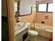 Bathroom with pink tile and vintage bathtub at 18006 4Th E St, Redington Shores, FL 33708