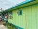 Beach cottage with a teal and green exterior at 18006 4Th E St, Redington Shores, FL 33708