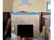 Bright fireplace with yellow brick and blue mantle ready for your personal touches at 18006 4Th E St, Redington Shores, FL 33708