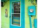 Bright teal front door with a glass window at 18006 4Th E St, Redington Shores, FL 33708