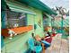 Charming patio with colorful accents, flower boxes, and ample seating for enjoying the outdoors at 18006 4Th E St, Redington Shores, FL 33708