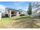 Spacious backyard with covered patio, hot tub, and grassy area at 18811 Deer Tracks Loop, Lutz, FL 33558