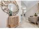 Bright and spacious entryway with tile flooring, decorative mirror, and seating area at 18811 Deer Tracks Loop, Lutz, FL 33558