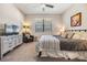 Spacious main bedroom with king-size bed, dresser, and sitting chair at 18811 Deer Tracks Loop, Lutz, FL 33558