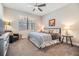 Relaxing main bedroom with a king-size bed, large TV, and plenty of natural light at 18811 Deer Tracks Loop, Lutz, FL 33558