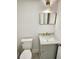Modern bathroom with gray vanity and gold fixtures at 19018 Geraci Rd, Lutz, FL 33548
