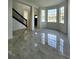 Bright living room with large windows and tile floors at 19018 Geraci Rd, Lutz, FL 33548