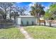 Landscaped backyard with detached workshop and palm trees at 2353 Grove S St, St Petersburg, FL 33705