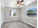 Bright bedroom with neutral walls, ceiling fan, and vinyl flooring at 2353 Grove S St, St Petersburg, FL 33705