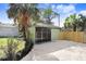 Detached garage with black barn doors and gravel driveway at 2353 Grove S St, St Petersburg, FL 33705