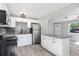 Updated kitchen with white cabinets, granite counters, and stainless steel appliances at 2353 Grove S St, St Petersburg, FL 33705