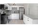 Renovated kitchen with white cabinets, granite countertops and gray backsplash at 2353 Grove S St, St Petersburg, FL 33705