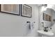 Small powder room with pedestal sink and decor at 2704 W Gray St # B, Tampa, FL 33609