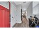 Bright entryway with red door, hardwood floors, and mirror at 2704 W Gray St # B, Tampa, FL 33609