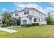 Two-story house with gray siding, attached garage, and well-maintained lawn at 2704 W Gray St # B, Tampa, FL 33609