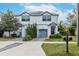 Two-story house with gray siding, attached garage, and landscaped yard at 2704 W Gray St # B, Tampa, FL 33609