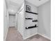Hallway with floating shelves and carpet at 2704 W Gray St # B, Tampa, FL 33609