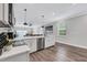 Modern kitchen with white cabinets, stainless steel appliances, and island at 2704 W Gray St # B, Tampa, FL 33609