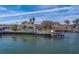 Aerial view of waterfront home with dock and yard at 2801 Hibiscus W Dr, Belleair Beach, FL 33786