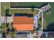 Aerial view showcasing the home's orange tile roof and backyard patio at 2801 Hibiscus W Dr, Belleair Beach, FL 33786