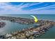 Aerial view showcasing waterfront home and canal access at 2801 Hibiscus W Dr, Belleair Beach, FL 33786