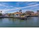 Aerial view of waterfront home with dock and yard at 2801 Hibiscus W Dr, Belleair Beach, FL 33786