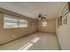 Simple bedroom with ceiling fan and large windows at 2801 Hibiscus W Dr, Belleair Beach, FL 33786