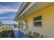 House exterior with patio seating and water views at 2801 Hibiscus W Dr, Belleair Beach, FL 33786