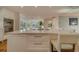Kitchen island with seating and built-in wine cooler at 2801 Hibiscus W Dr, Belleair Beach, FL 33786